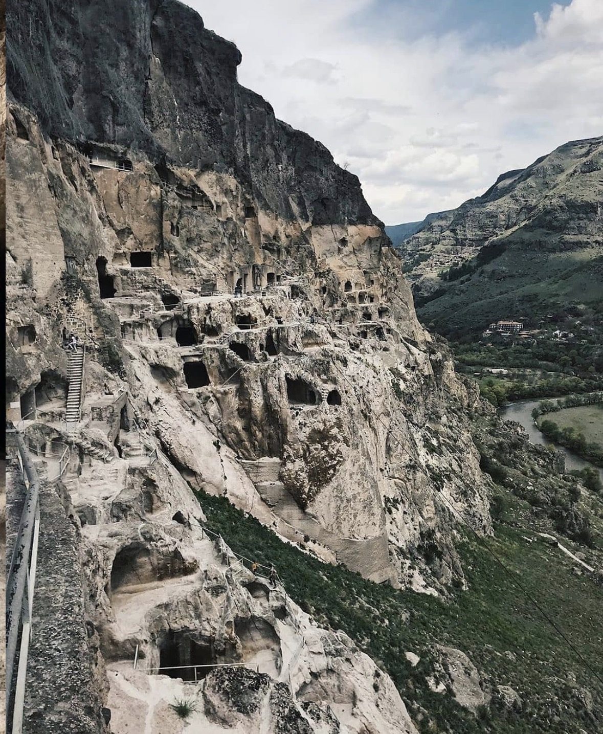 Narrow cave tunnel inside Vardzia monastery complex showing uneven rock floors and low ceilings